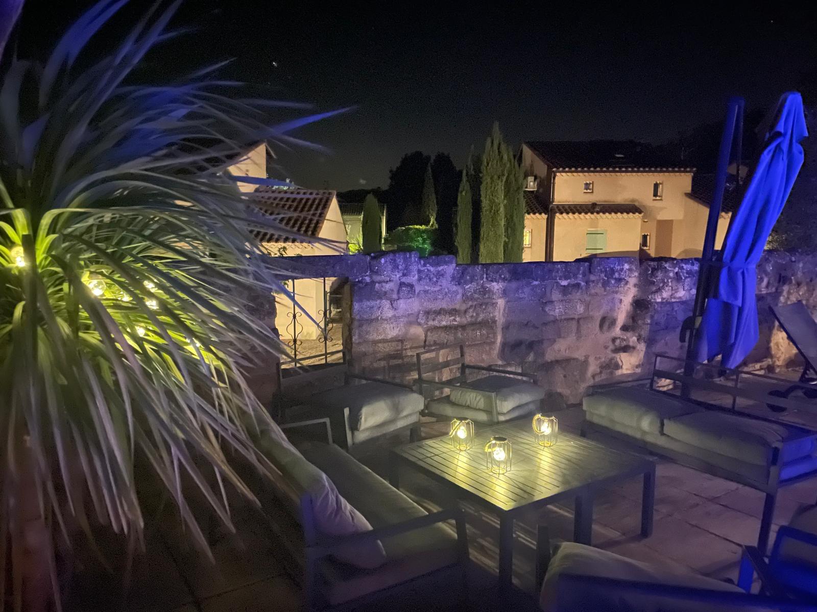 Terrasse lounge du mas éclairée aux lanternes le soir